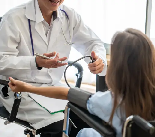 Physician taking blood pressure readings from patient in a wheelchair | Coastal River Weight Loss Clinic